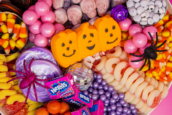 Close up of pink, orange, and purple candies for pink disco Halloween candy charcuterie board