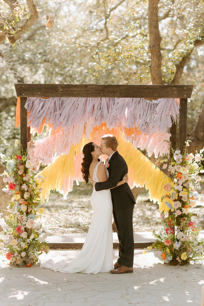 Couple kisses during spring wedding in Austin, Texas