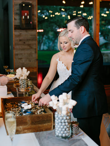 Bride and groom making s'mores to celebrate their wedding day