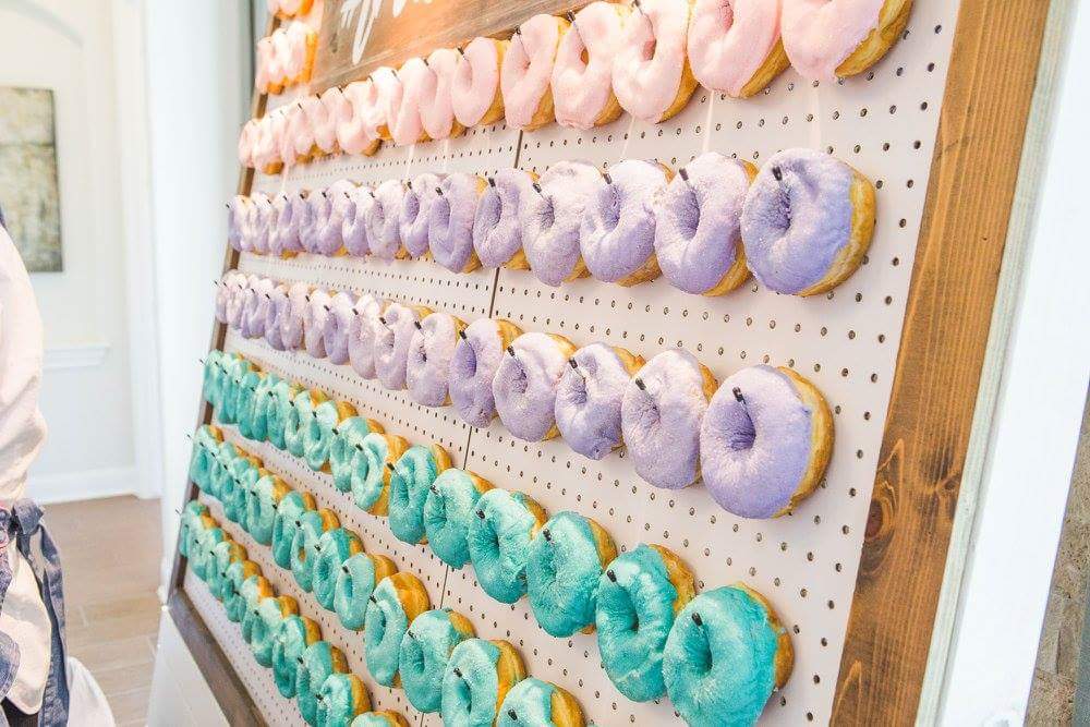Pink, purple, and turquoise glazed doughnuts make a stunning statement piece on our doughnut wall