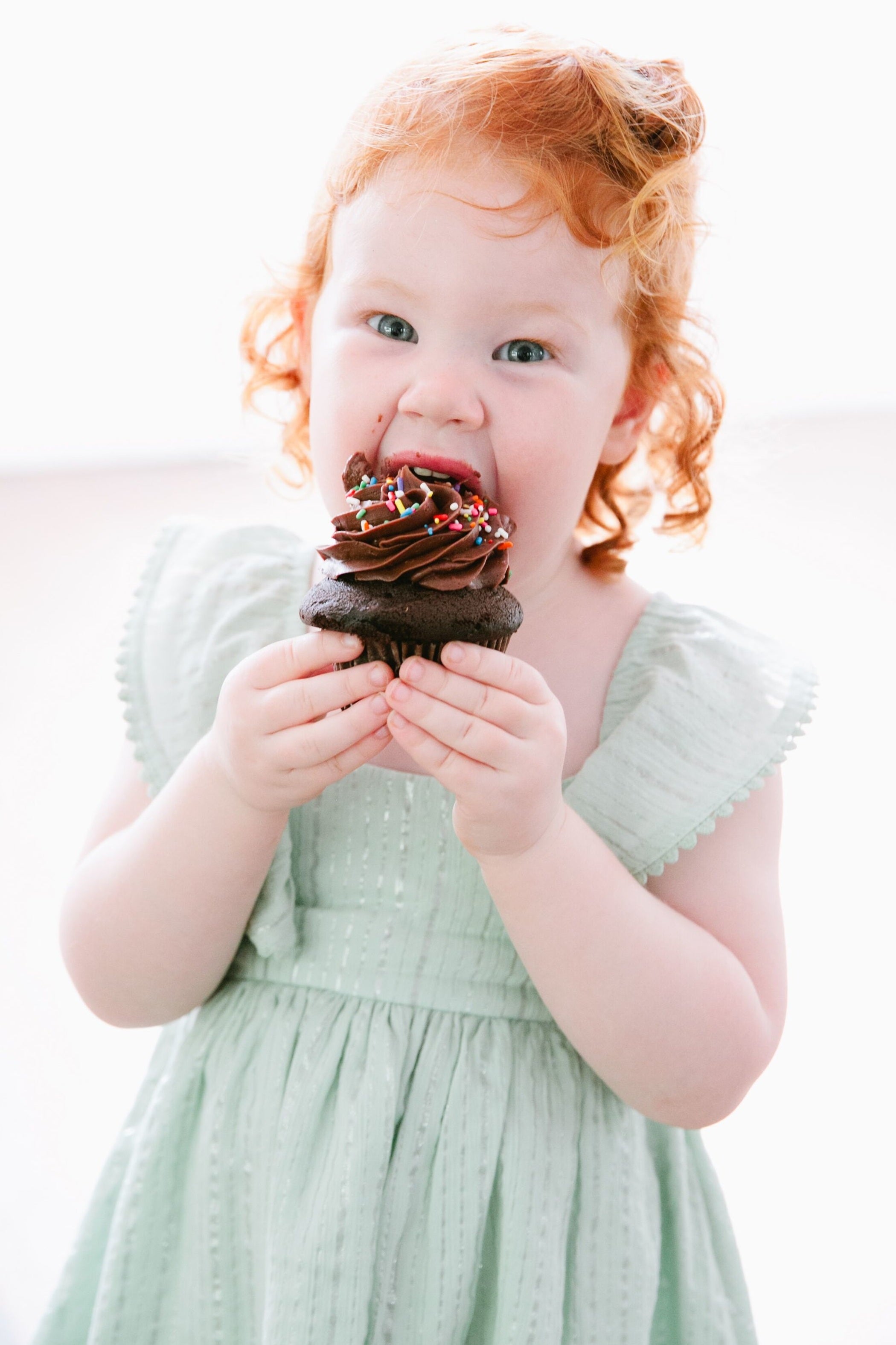 Little girl eats Custom Cupcake Austin Texas