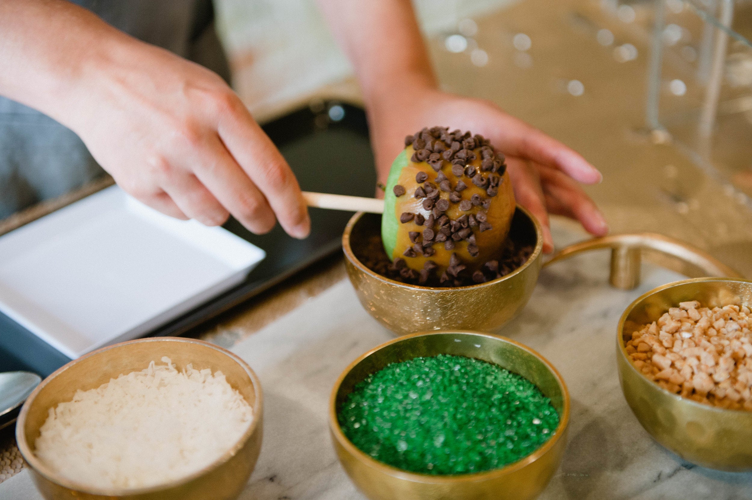 Toppings at a custom caramel apple bar at an Austin, Texas fall wedding