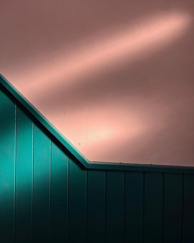 hallway wall and wooden wall panelling painted in warm peach and warm green colours