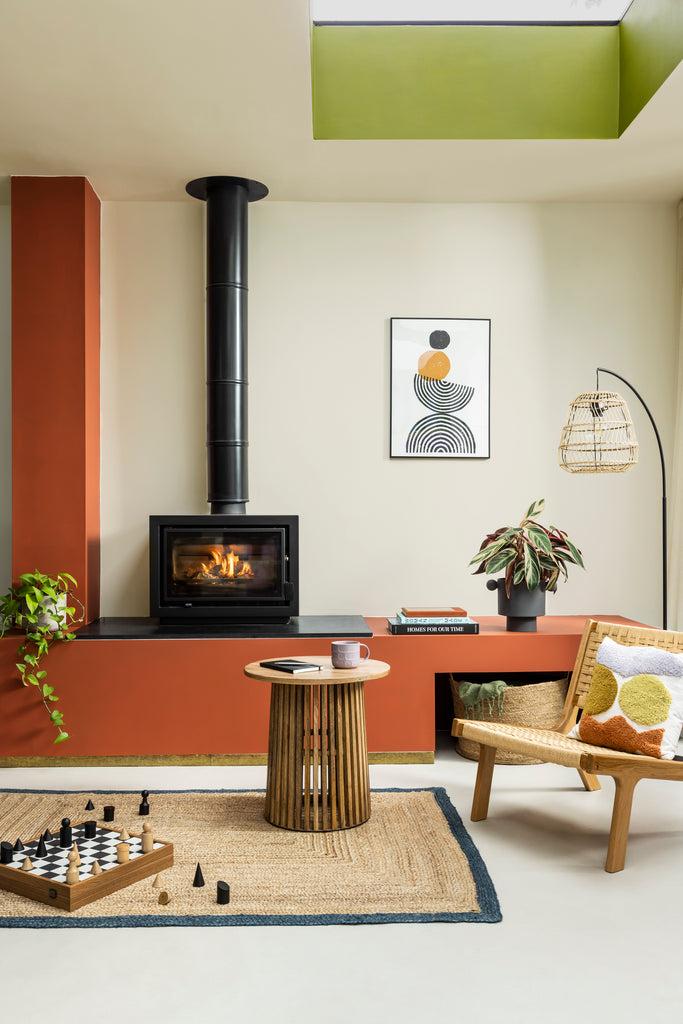 rustic living room with wall cabinets painted in YesColours Loving Orange, neutral walls, green ceiling and vintage fireplace