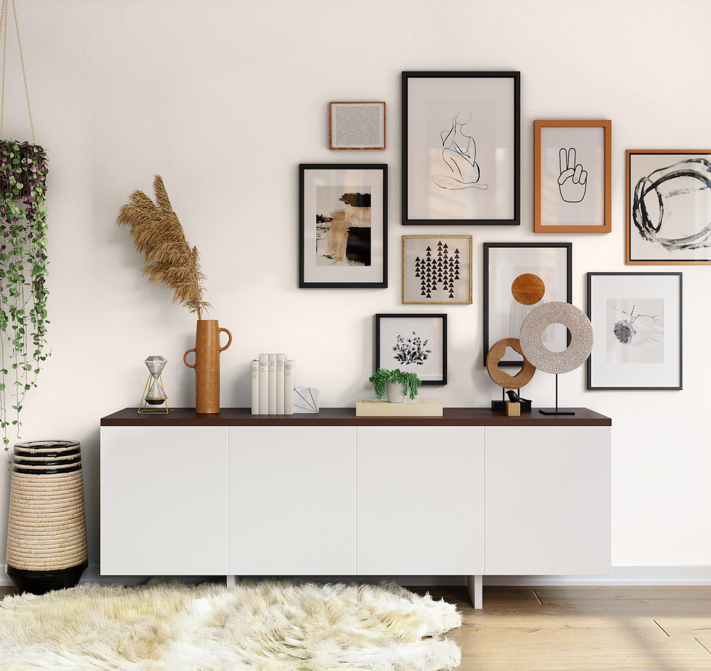 Photo of a warm neutral gallery wall with various photos attached on it, neutral sideboard and a big fluffy white rug placed on a light warm-coloured wooden floor