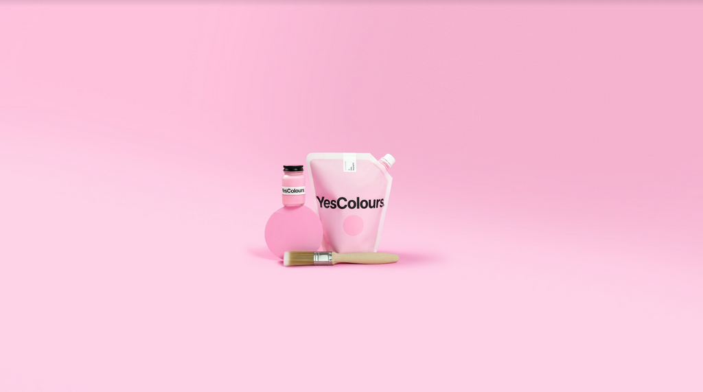 Still life product image of YesColours paint pouch and sample pot, photographed in front of a Joyful Pink pastel pink background