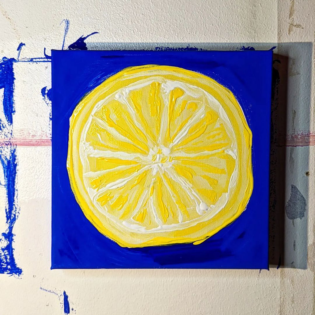 Bright yellow lemon painting artwork painted on YesColours Electric Blue paint colour background