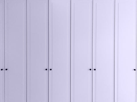 a close up of a wide and tall wardrobe with narrow doors all painted in a light lilac shade