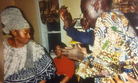 Imani McFarlane dance with friends all dressed in traditional West African attire