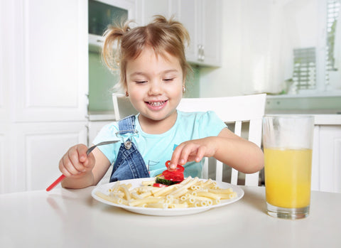 Little girl excited to eat some pasta