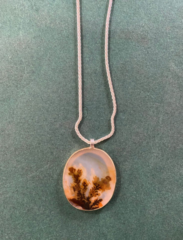 Dendritic Agate Necklace on a green background