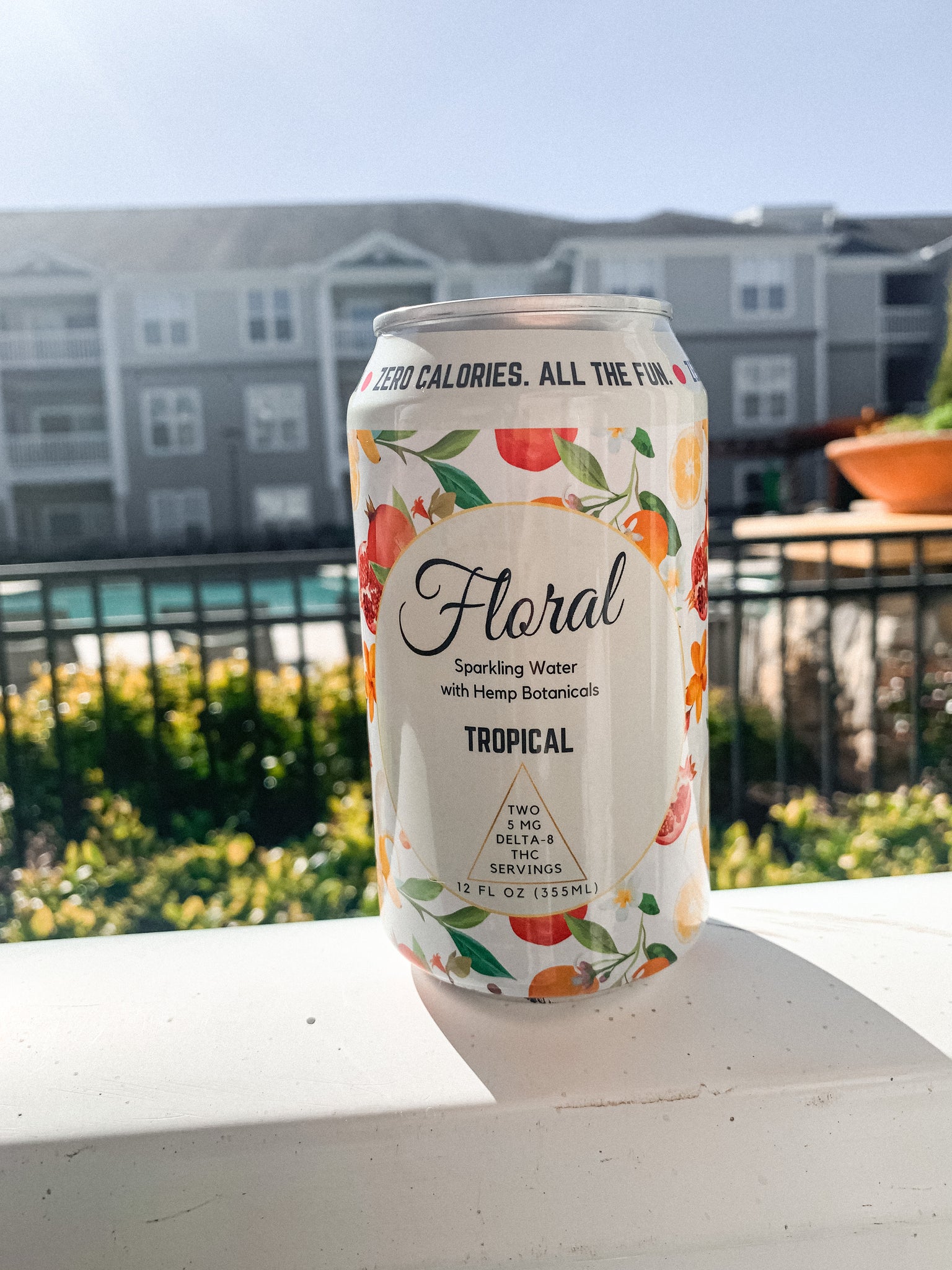 A can of Floral Beverages Tropical THC-infused seltzer sitting outside on a sunny day.