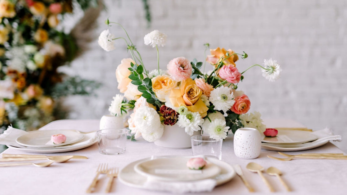 Revelry tablescape in Austin texas with velvet pink table cloth and bright florals in center