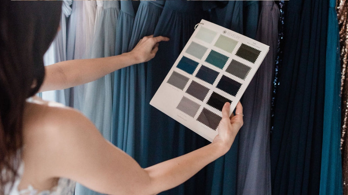 Two brides are better than 1 bride in blue luna revelry bridal gown holding up swatches in different blue and green tulle colors