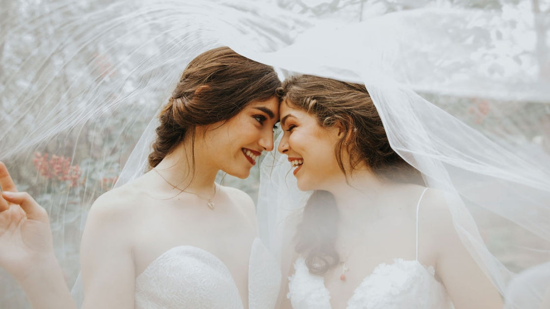 Two brides are better than 1 smiling and cuddling under veil on wedding day love marriage