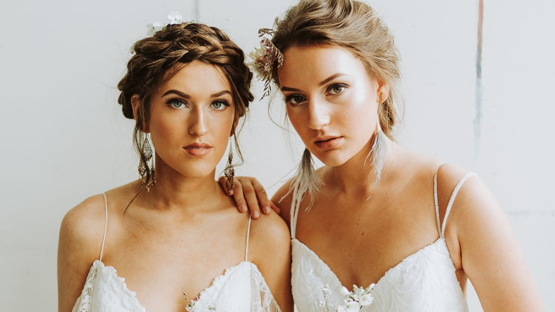 Two brides are better than 1 headshot of two brides in revelry bridal gowns posing on wedding day