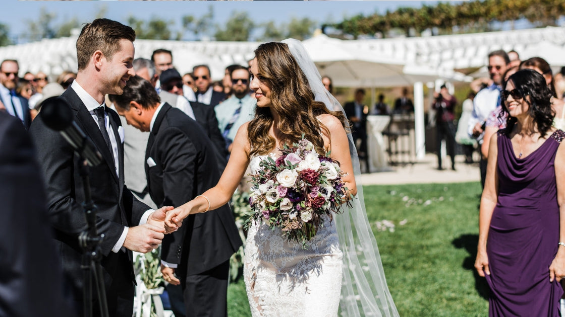 Brunette bride in lace off white champagne wedding dress veil purple flowers marrying the love of her life