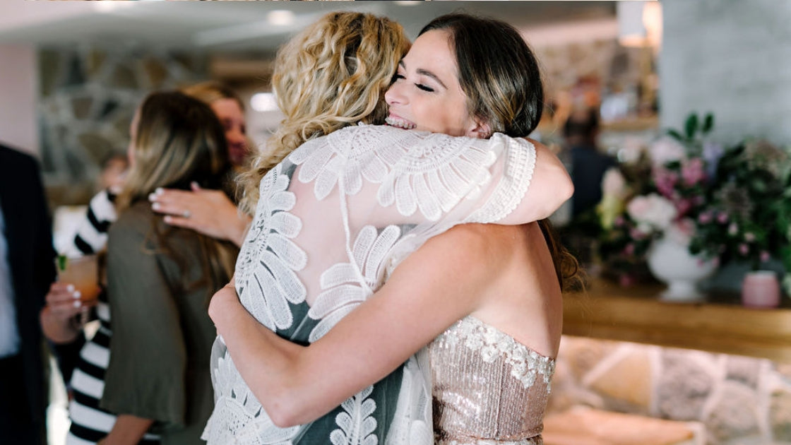 Michelle deloach founder of revelry rose gold sequin cocktail dress hugging guests as they arrive to p6 party in downtown austin