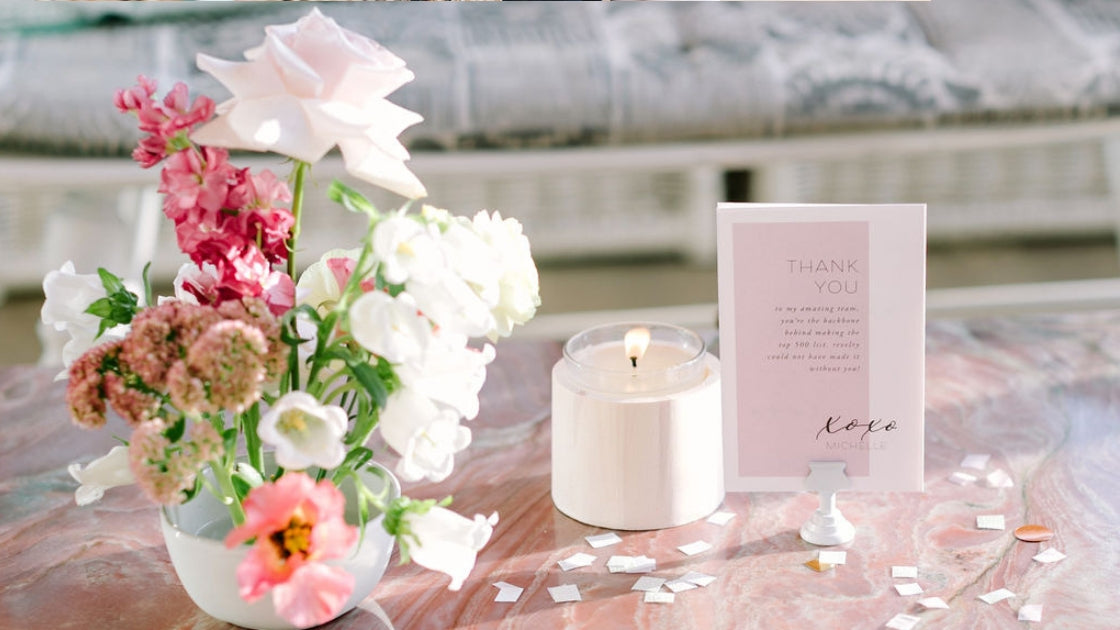 Table setting pink marble flowers pink white florals white candle thank you note to team mauve color note