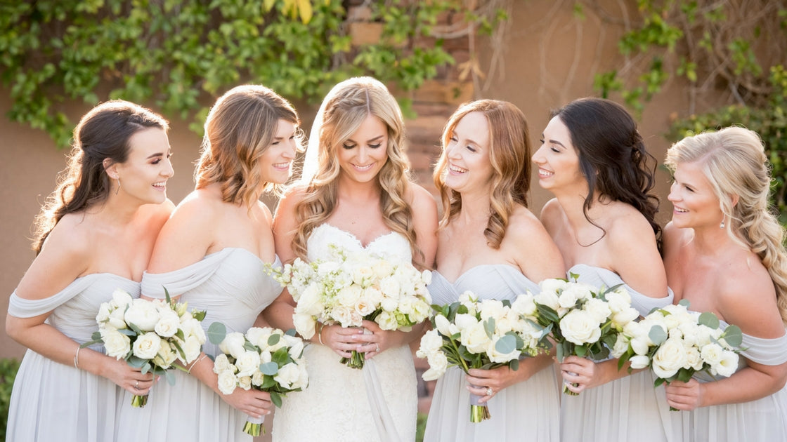 girls hugging in long chiffon bridesmaid dresses from Revelry.