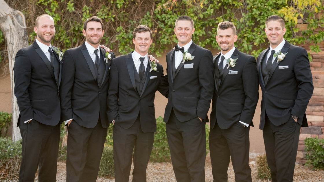 Groom and groomsmen pose together. 