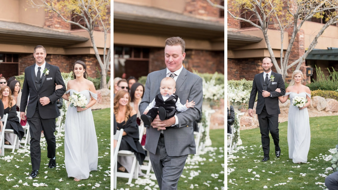 Bridesmaids walk down the aisle and friend carries ring bearer down the aisle. 