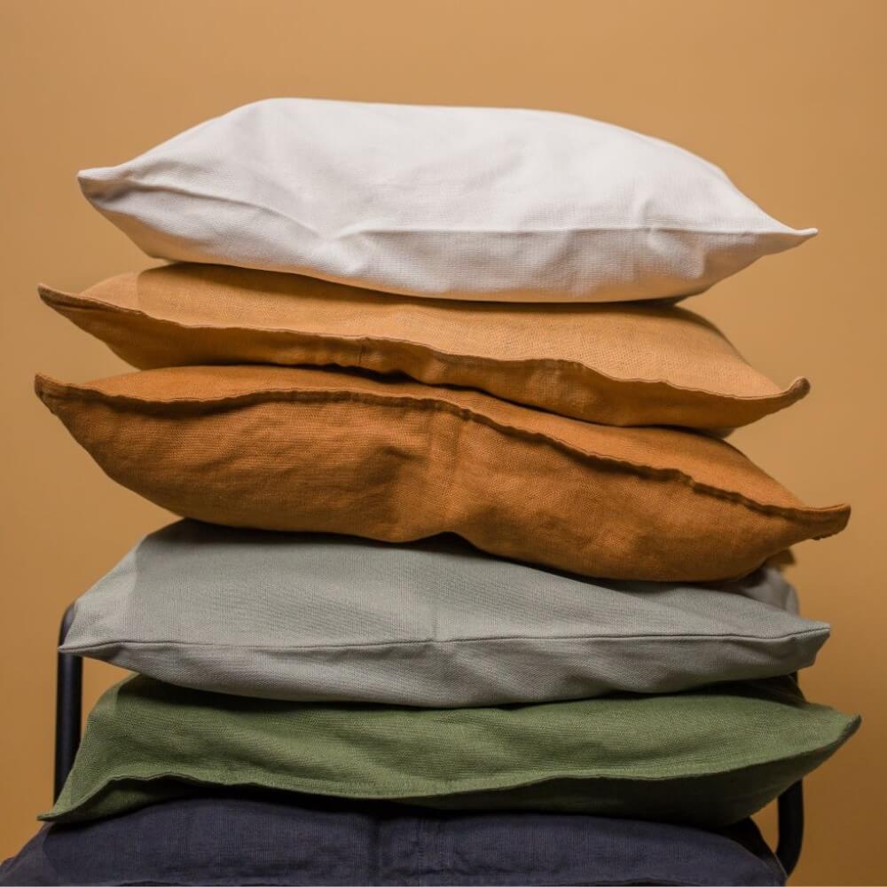 pile of earth-toned pillows perfect for a dog's bed