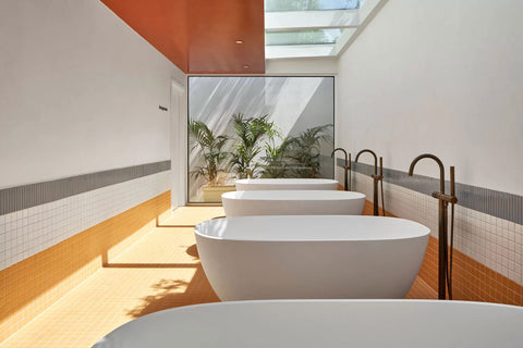 Alternate view of the bathtubs, featuring a bright yellow floor and a contrasting orange ceiling, enhancing the vibrant ambiance.