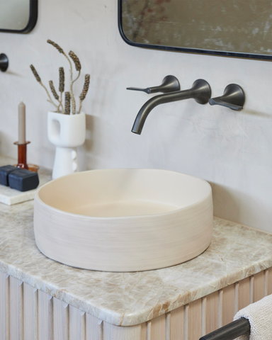 A close-up view of the elegant 'Nood' Slip basin, the centerpiece of this beautifully designed second bathroom.