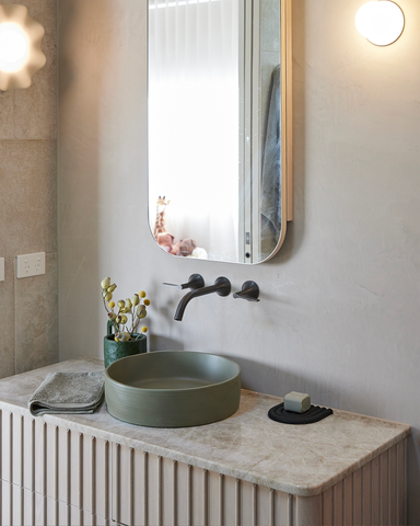 A close-up view of the Olive Slip basin, showcasing its elegant design in a modern bathroom.