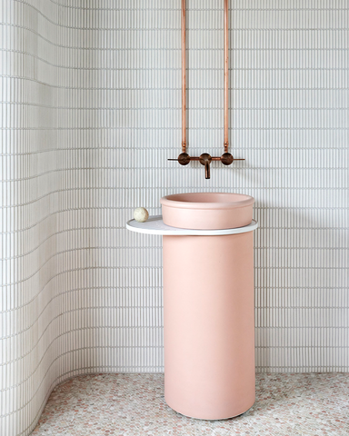 Tubb Cylinder in Blush Pink with an Ivory Tray against a curved finger tile wall.