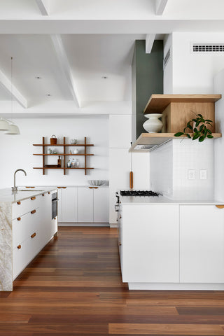 Stylish coastal-mid-century kitchen featuring natural stone Taj Mahal island in Mandurah residence.