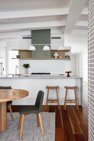 Well-lit, spacious kitchen with state-of-the-art features and natural stone accents in Mandurah Foreshore home.