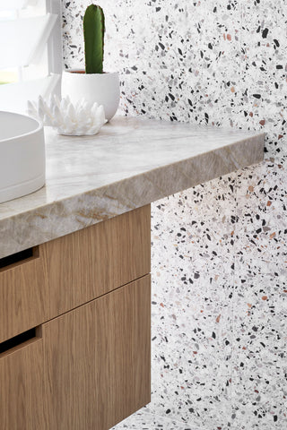 Sophisticated primary bathroom with double Nood Co Pill basins in Ivory, terrazzo tiles, and natural stone Taj Mahal benchtop.