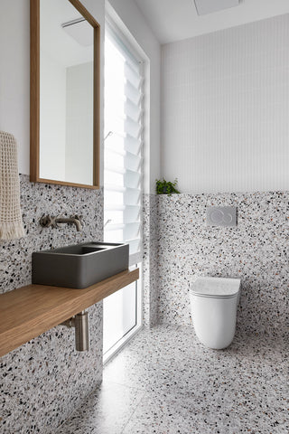 Chic powder room with Nood Co Shelf 01 basin in Mid Tone Grey and matte white kit kat mosaic tiles.