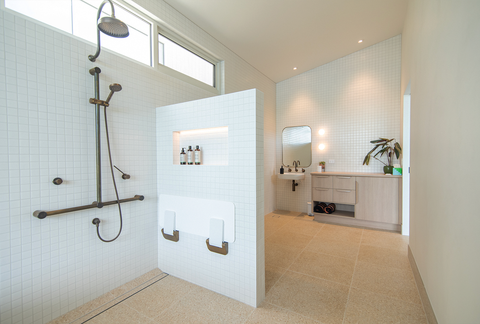 Edge Luxury Villas by Studio Situs featuring all Australian products including Faucet Strommen tapware in aged brass and Nood Co Shelf Oval basin in Ivory in a bathroom designed for accessibility.