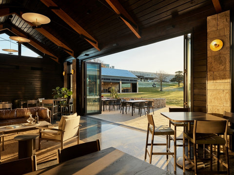 From the interior of Taylors Wines, a captivating view unfolds through large windows. The expansive winery estate stretches before you, revealing rows of meticulously tended vineyards against the backdrop of rolling hills. The warm, inviting ambiance of the interior seamlessly connects with the natural beauty of the surrounding Clare Valley landscape.