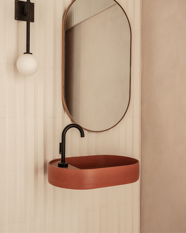 Chic Musk Shelf Oval basin in rich tones, set against a crisp white brick backdrop, accented with sleek black tapware.