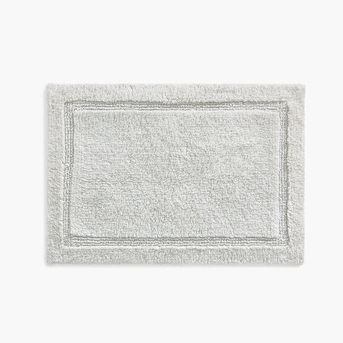 https://cdn.shopify.com/s/files/1/0557/8840/4900/products/plush-organic-cotton-reversible-bath-rug-oyster-gray-front_large.jpg?v=1685457861