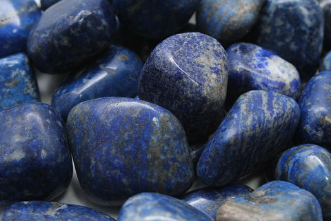 Polished lapis lazuli tumbles in various shades of blue and gold