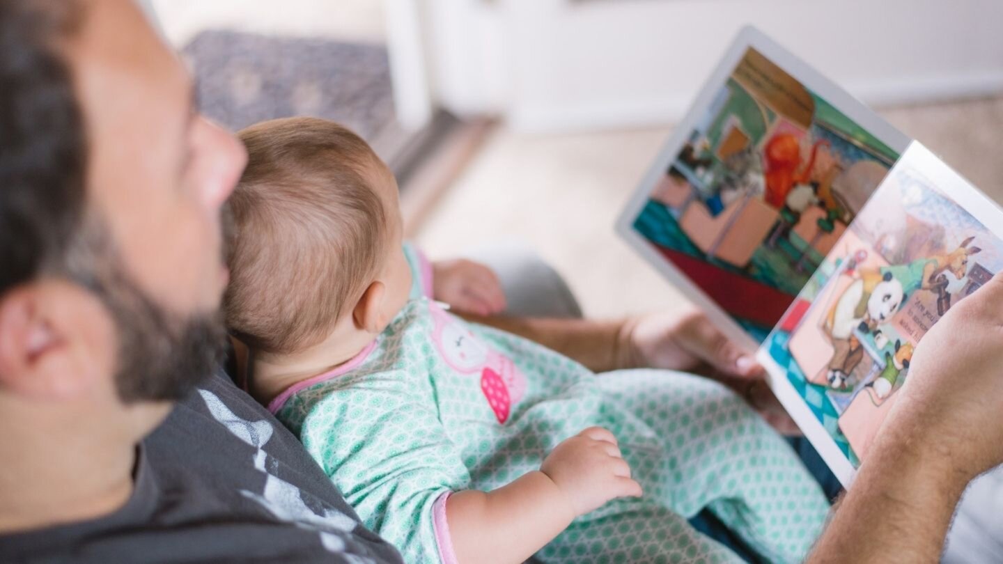 first-time-dad-reading-to-baby