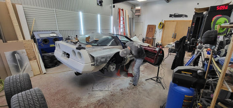 Sanded down corvette custom fiberglass sides with man in the photo.