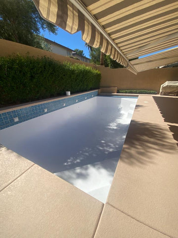 Newly re-gelcoated pool in backyard, by an awning.