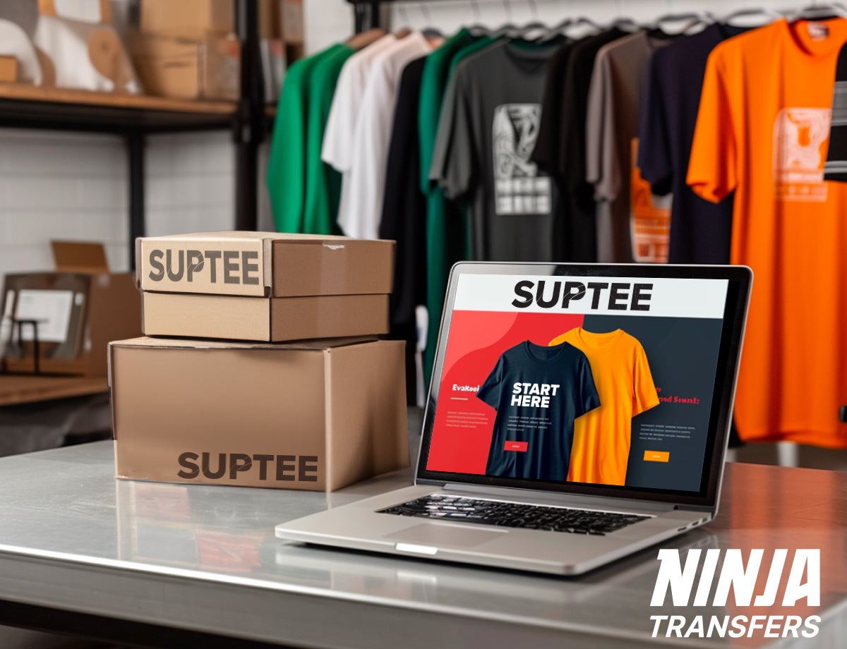 Laptop on a desk, displaying an online t-shirt storefront. The background has various t-shirts hanging on a rack, and boxes with logo on them stacked up and ready to ship.