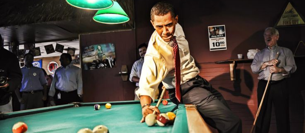 obama playing billiards in a bar