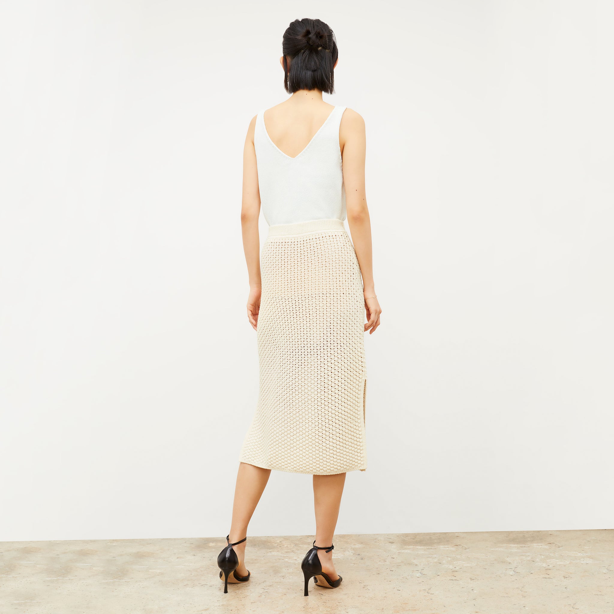 Back image of a woman wearing the Senga skirt in coconut