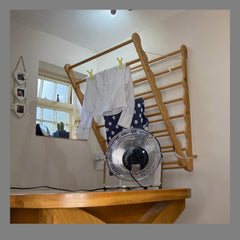 The laundry ladder drying clothes with a fan to aid the drying process