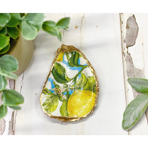 an oyster shell decorated with a lemon fruit image