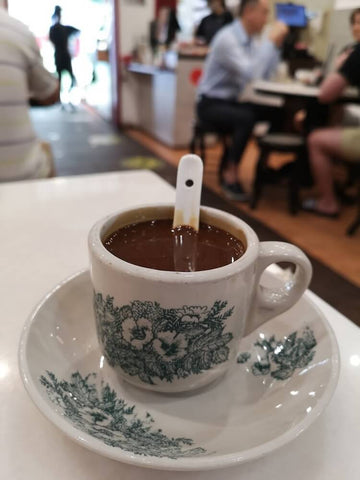Kopi served in traditional ceramic cup and saucer. Photo by Zac Sws.