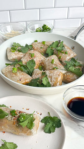 Crispy rice paper dumplings in the Cosmo Fry non-stick pan and plate, with dipping sauce on the side.